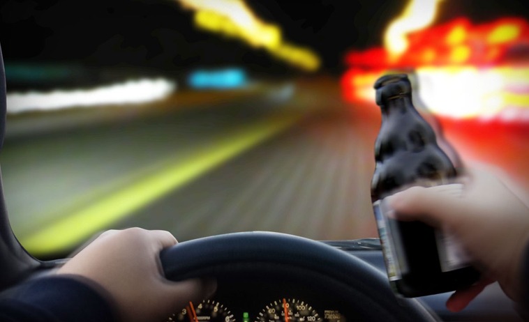 Photo of a person drinking and driving
