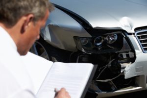 loss adjuster inspecting damages after auto wreck